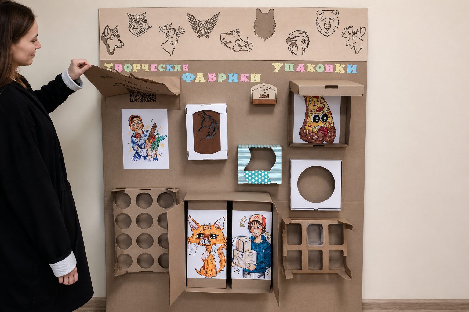 A large wall of cardboard packaging prototypes and illustrated panels
